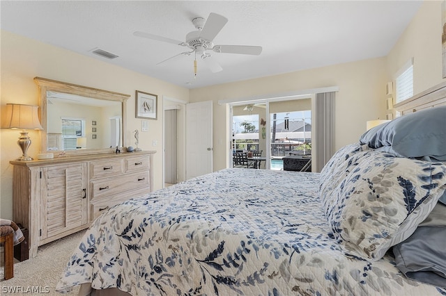 bedroom featuring access to exterior, light colored carpet, and ceiling fan