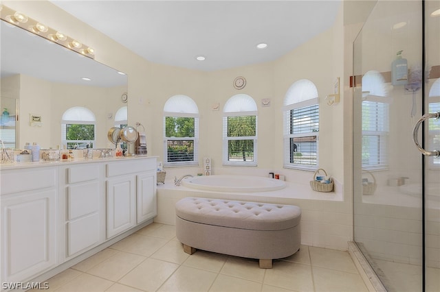 bathroom with tile patterned floors, vanity, and independent shower and bath