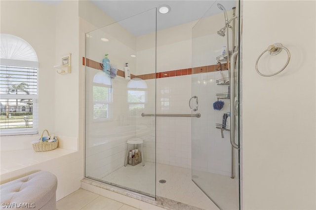 bathroom with tile patterned flooring and a shower with door