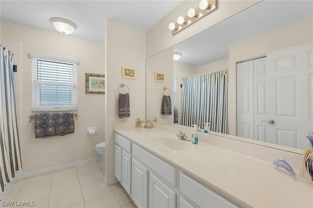 bathroom with toilet, a textured ceiling, vanity, and tile patterned floors