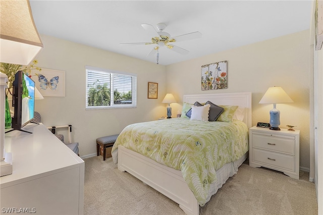 bedroom with ceiling fan and light carpet