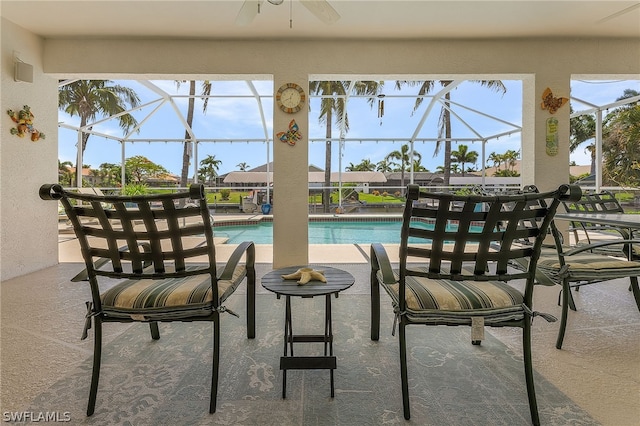 view of swimming pool with a lanai, ceiling fan, and a patio