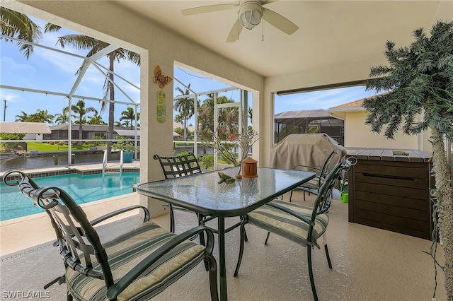 sunroom / solarium featuring a water view and ceiling fan