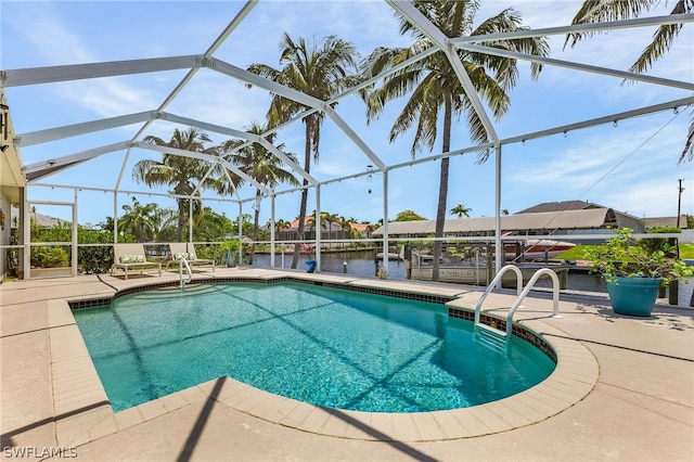 view of swimming pool with a patio, a water view, and glass enclosure