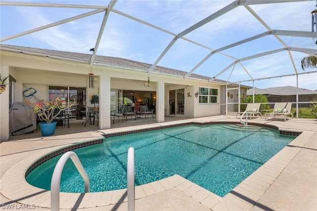 view of swimming pool with a lanai, a patio area, and ceiling fan