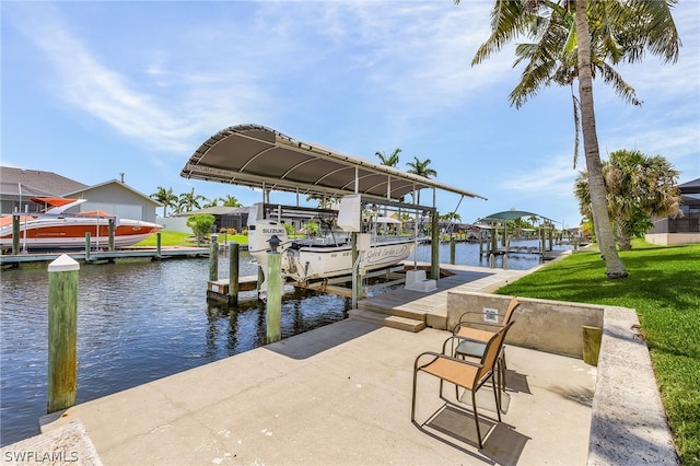 view of dock with a lawn and a water view