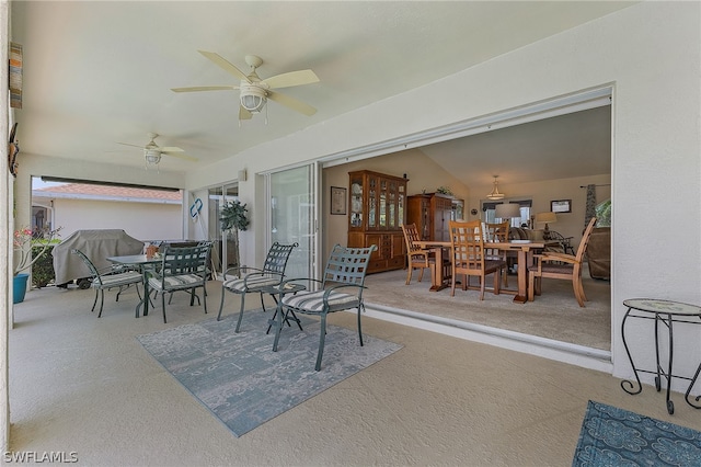 exterior space featuring ceiling fan and vaulted ceiling