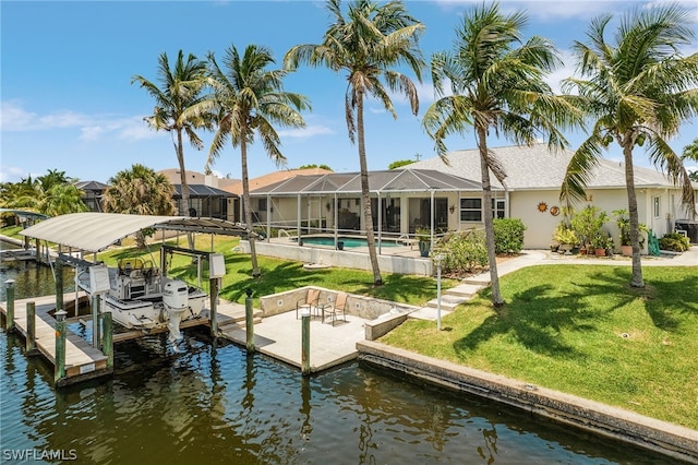 dock area featuring a yard, a water view, and a lanai