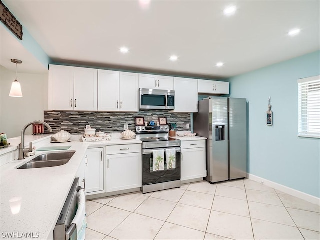 kitchen with white cabinetry, sink, pendant lighting, and appliances with stainless steel finishes