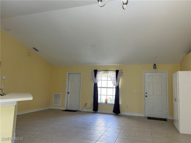 tiled foyer entrance with vaulted ceiling