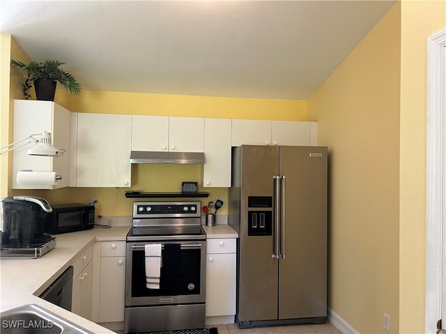 kitchen with white cabinets, light tile patterned flooring, and stainless steel appliances