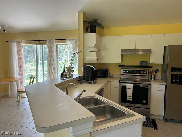 4720 22nd Ave SE, Naples, FL 34117 - kitchen featuring stainless steel appliances, under cabinet range hood, a peninsula, light tile patterned flooring, and a sink