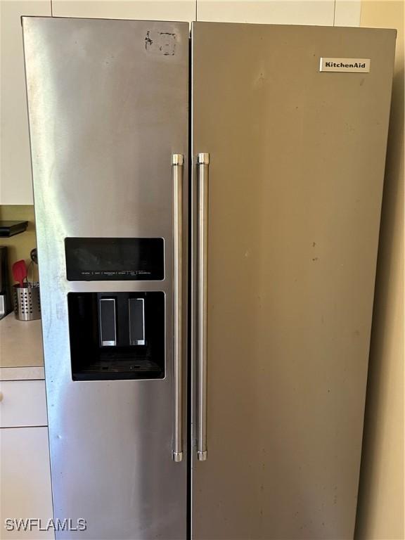 interior details featuring stainless steel fridge with ice dispenser