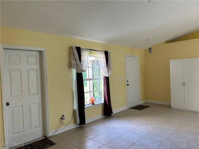 4720 22nd Ave SE, Naples, FL 34117 - foyer entrance with light tile patterned flooring, vaulted ceiling, and baseboards