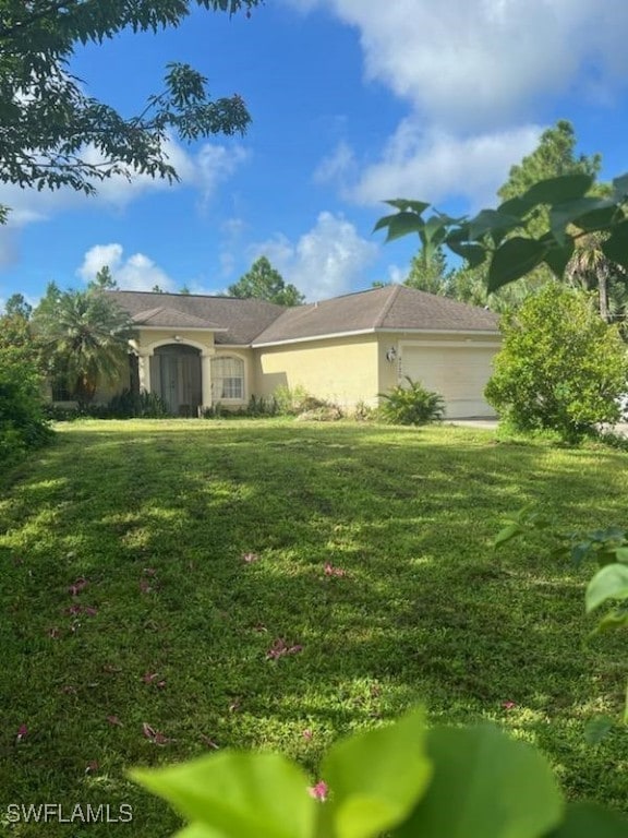 exterior space featuring a front yard and a garage