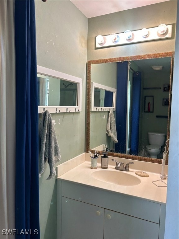 bathroom featuring vanity and toilet