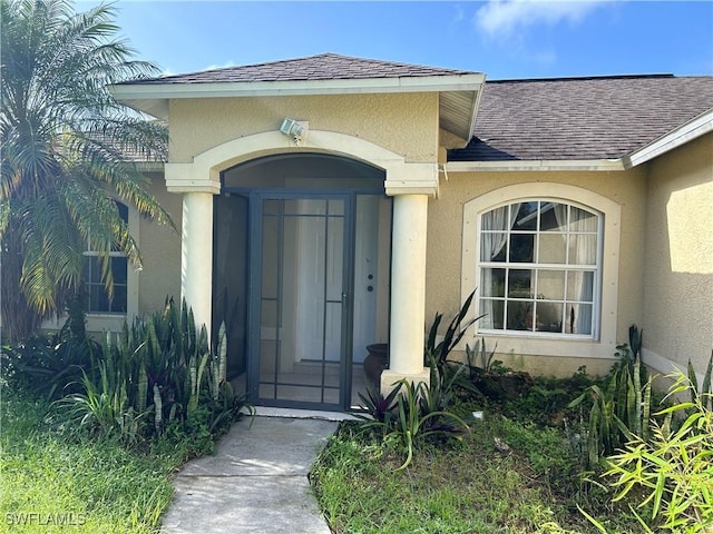 4720 22nd Ave SE, Naples, FL 34117 - view of exterior entry with roof with shingles and stucco siding