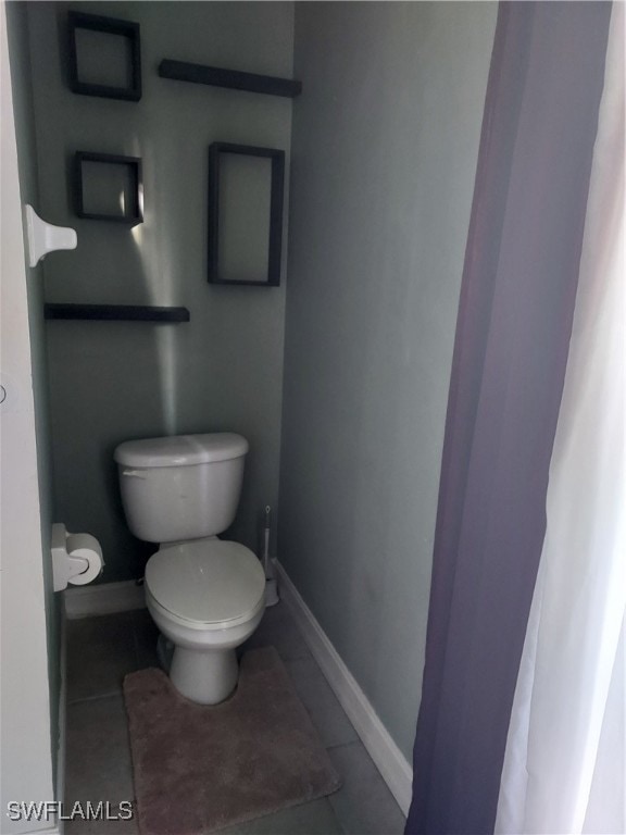 bathroom featuring toilet and tile patterned floors