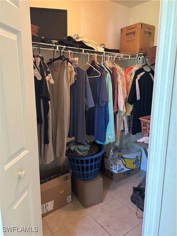 spacious closet with light tile patterned floors