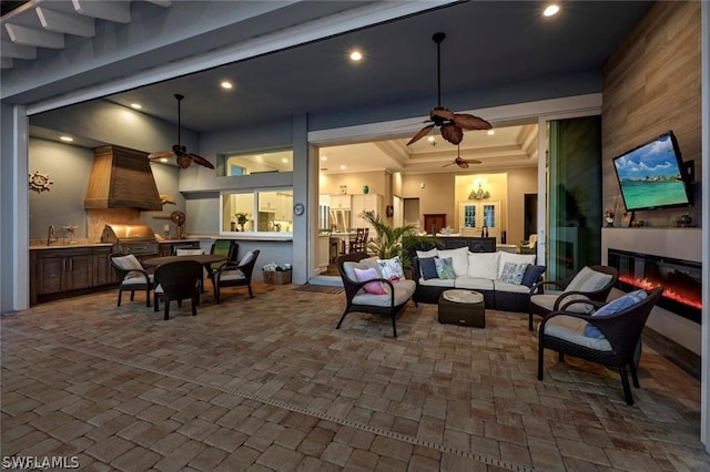 view of patio with area for grilling, an outdoor living space, and ceiling fan