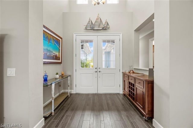 entryway featuring a chandelier, french doors, and dark wood-type flooring