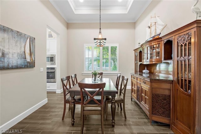 dining room with a notable chandelier, crown molding, and a tray ceiling