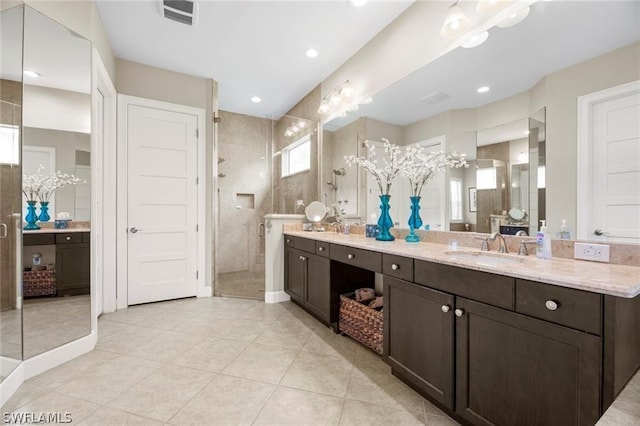 bathroom featuring vanity, tile patterned floors, and walk in shower