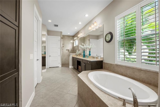 bathroom featuring tile patterned floors, separate shower and tub, and vanity