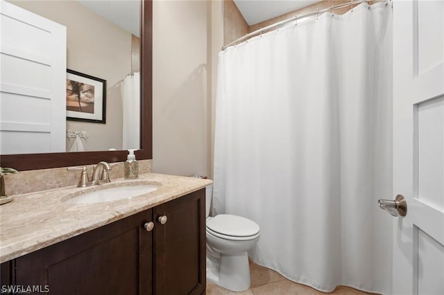 bathroom with tile patterned flooring, vanity, and toilet