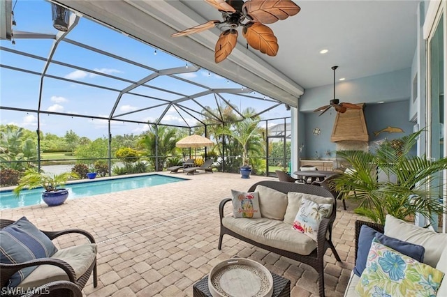 view of swimming pool with glass enclosure, a patio area, and an outdoor hangout area