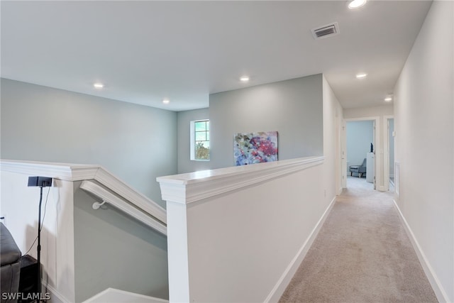 hallway featuring light carpet