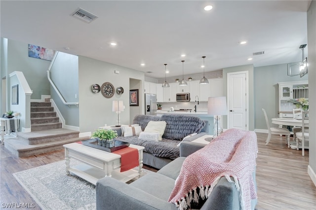 living room featuring light hardwood / wood-style floors and sink