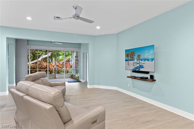 living room featuring ceiling fan and light wood-type flooring