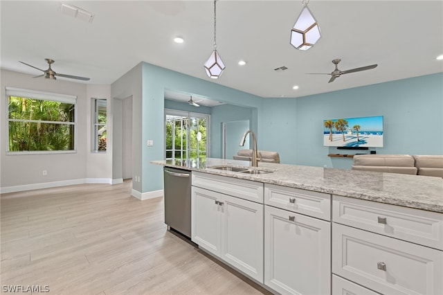 kitchen featuring pendant lighting, dishwasher, sink, and white cabinets