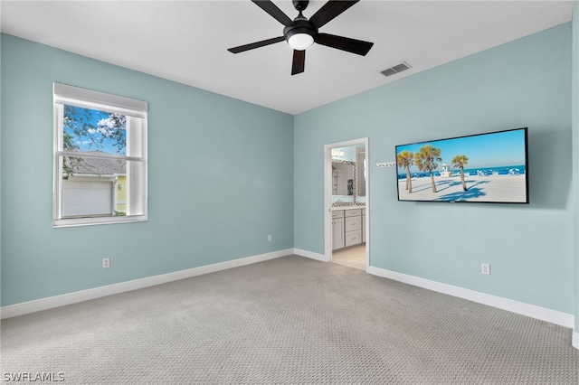 carpeted empty room featuring ceiling fan