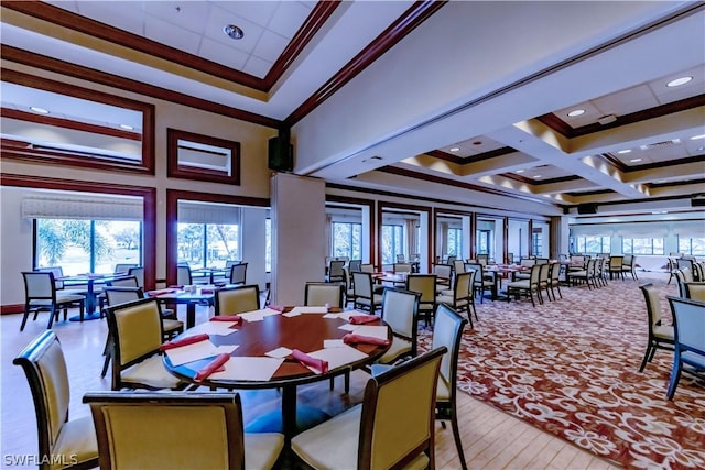 dining room with coffered ceiling, crown molding, and a towering ceiling