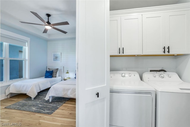 laundry room with ceiling fan, washer and clothes dryer, cabinets, and light hardwood / wood-style floors