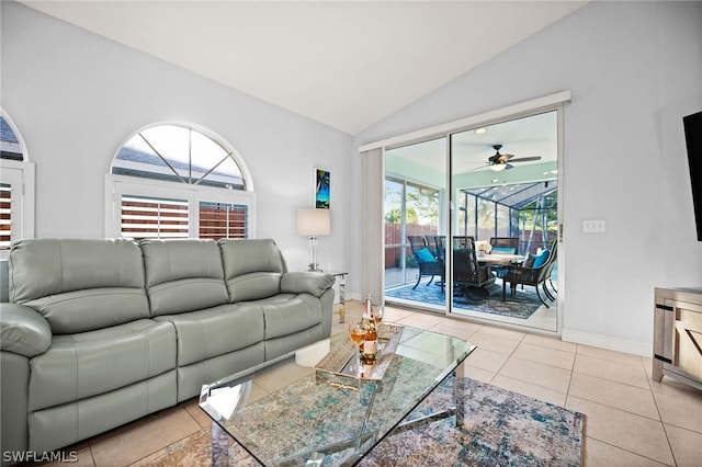 living room with ceiling fan, light tile patterned floors, and lofted ceiling