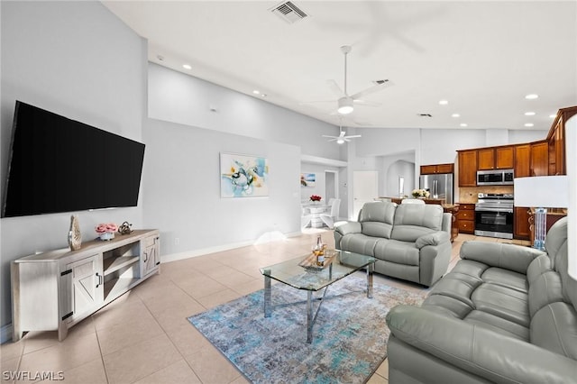 living room with ceiling fan, light tile patterned floors, and high vaulted ceiling