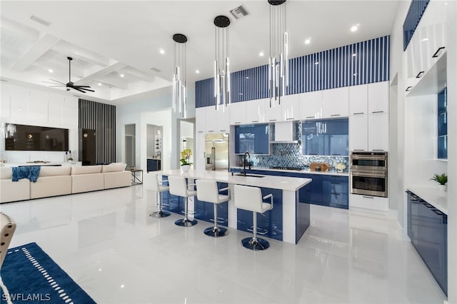 10 Caribbean Rd, Naples, FL 34108 - kitchen featuring a towering ceiling, a sink, and modern cabinets