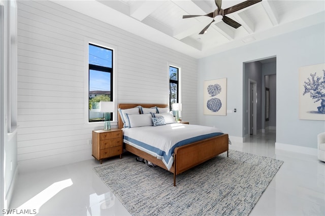 tiled bedroom with ceiling fan, coffered ceiling, and beam ceiling