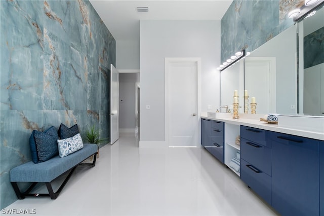 bathroom featuring vanity and tile walls