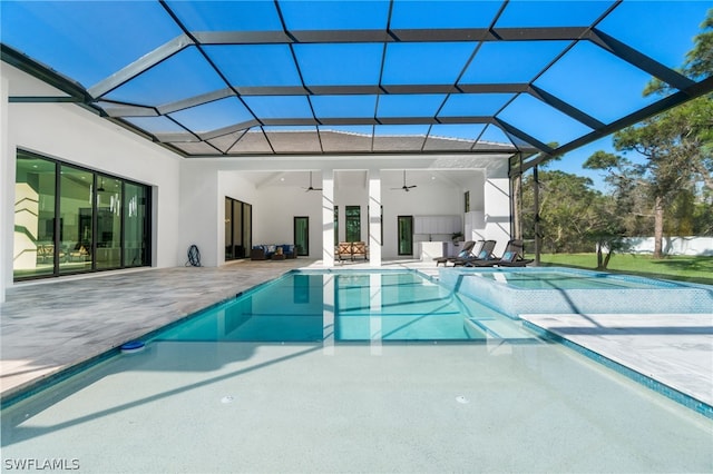 view of pool featuring a lanai, a patio area, and ceiling fan