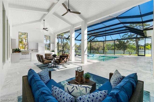 view of patio featuring exterior kitchen, an outdoor hangout area, ceiling fan, and glass enclosure