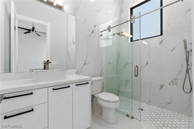 bathroom featuring an enclosed shower, vanity, toilet, and ceiling fan