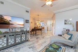 tiled living room with ornamental molding and ceiling fan with notable chandelier