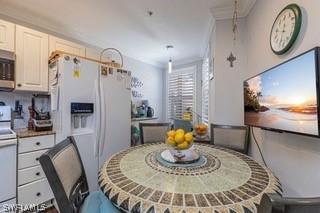 dining space featuring crown molding