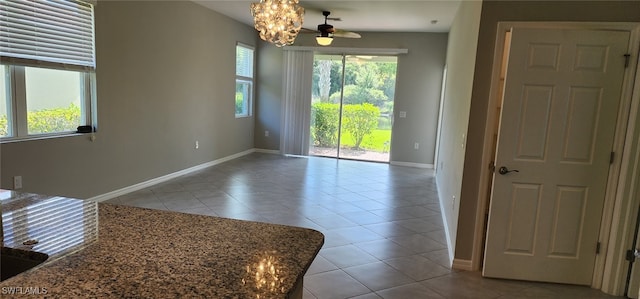 interior space featuring light tile patterned floors and an inviting chandelier