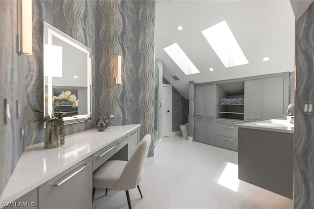 office area featuring sink, vaulted ceiling with skylight, and light tile floors