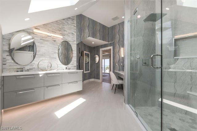 bathroom featuring an enclosed shower, vanity, and tile walls